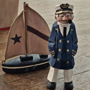 Nautical Carved Wooden Sailor Figurine with Sailboat